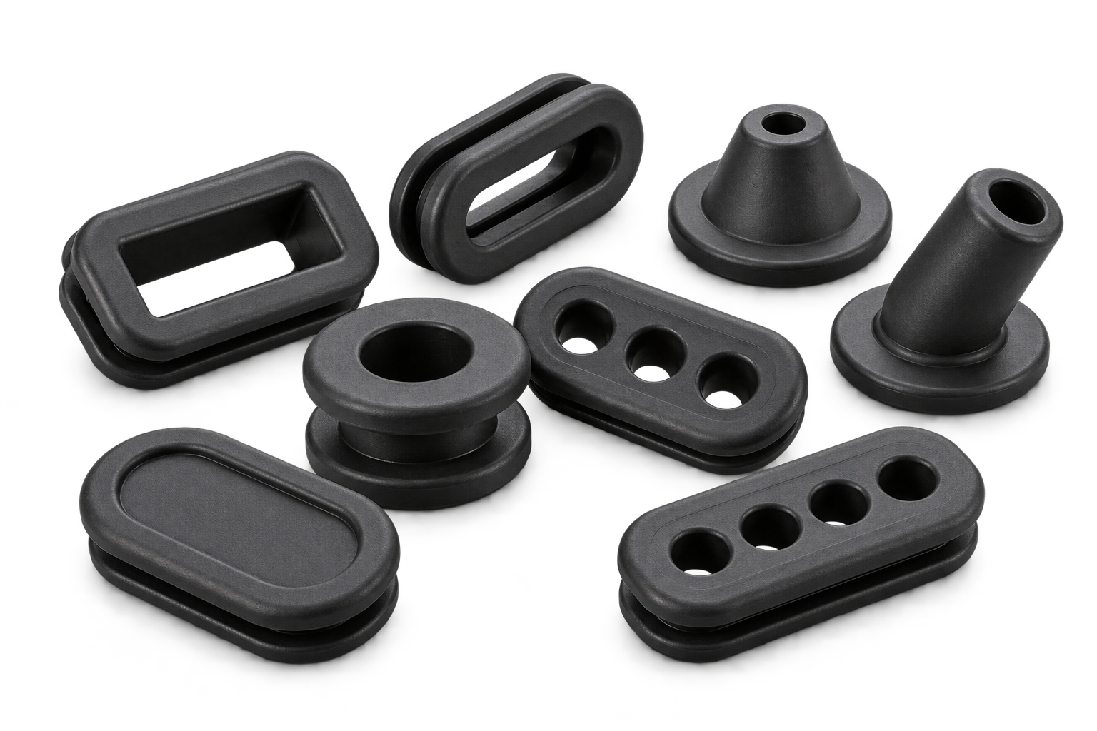 An assortment of custom rubber grommets with rectangular, round, multi-hole and long-neck profiles